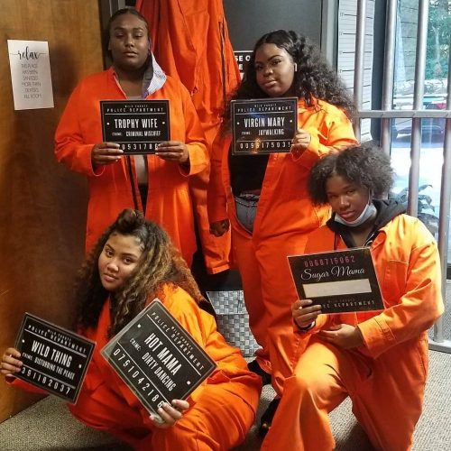 group of ladies in prisoners suites that just finished Prison Break team game
